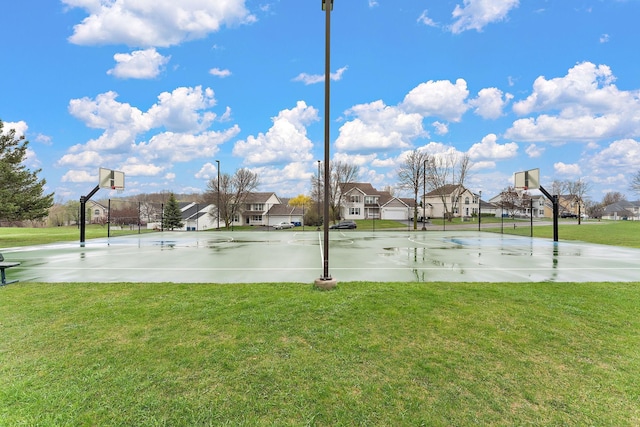 view of sport court featuring a lawn, community basketball court, and a residential view