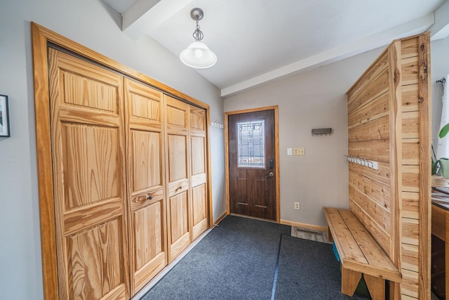 mudroom with dark carpet, baseboards, and vaulted ceiling with beams