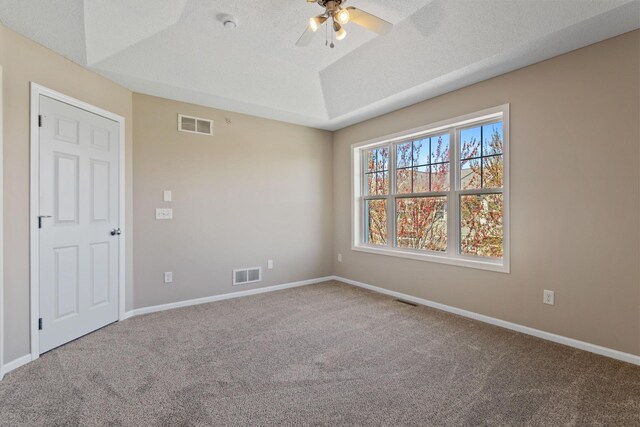 carpeted empty room featuring a ceiling fan and baseboards