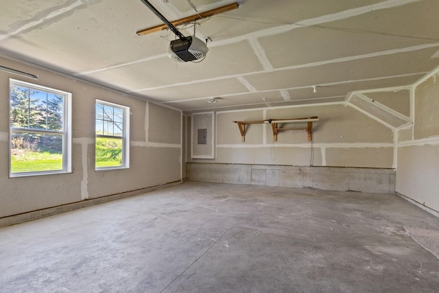 garage with a garage door opener and electric panel