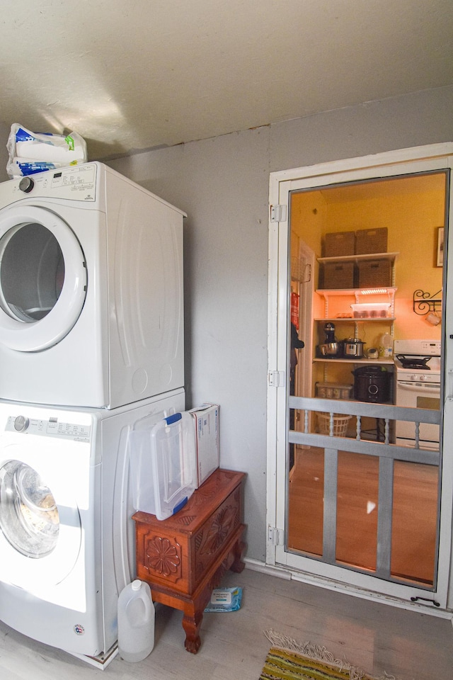 laundry area featuring stacked washer and dryer and laundry area