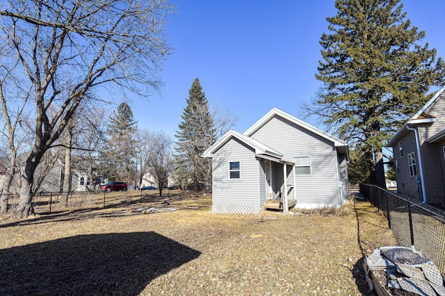 rear view of property featuring fence private yard