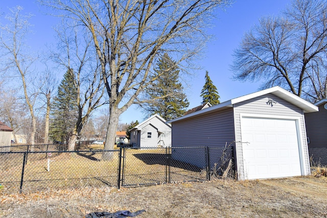 405 State Ave N, Thief River Falls, MN 56701 - view of side of property featuring an outdoor structure, a detached garage, and a gate