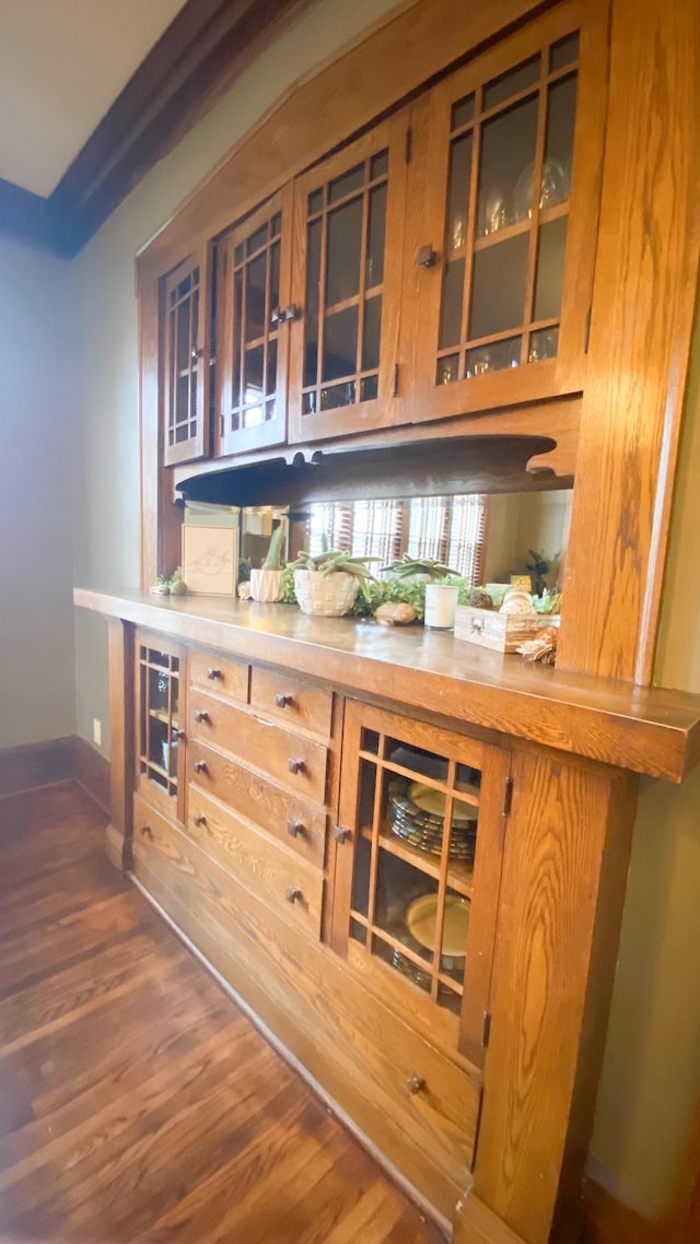 bar featuring baseboards and wood finished floors