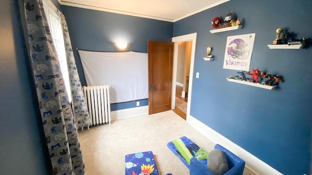 carpeted bedroom with radiator heating unit and baseboards