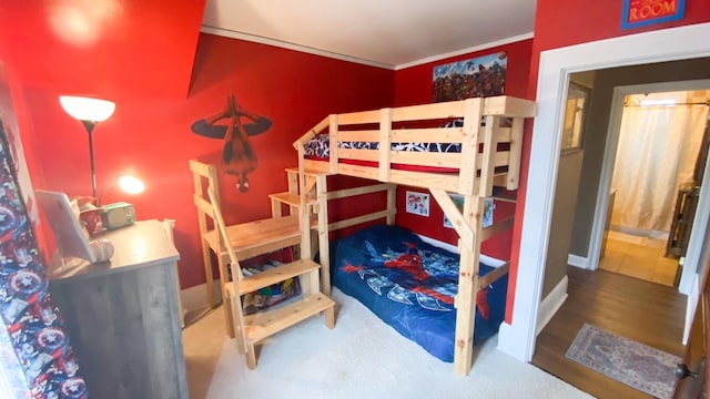bedroom featuring wood finished floors and baseboards