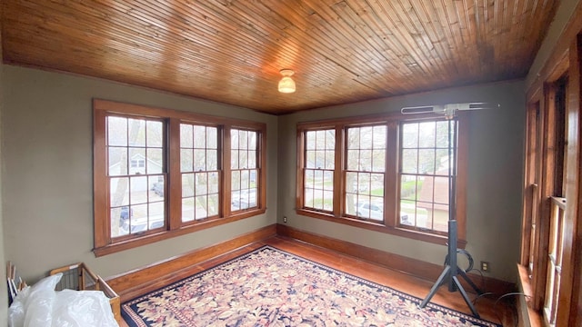 bedroom with baseboards and wood finished floors
