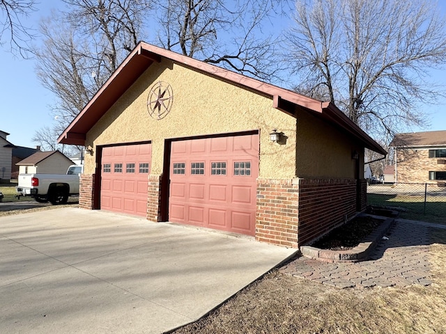detached garage featuring fence