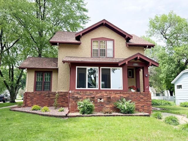 1201 6th Ave, Worthington, MN 56187 - view of front facade featuring stucco siding, brick siding, and a shingled roof