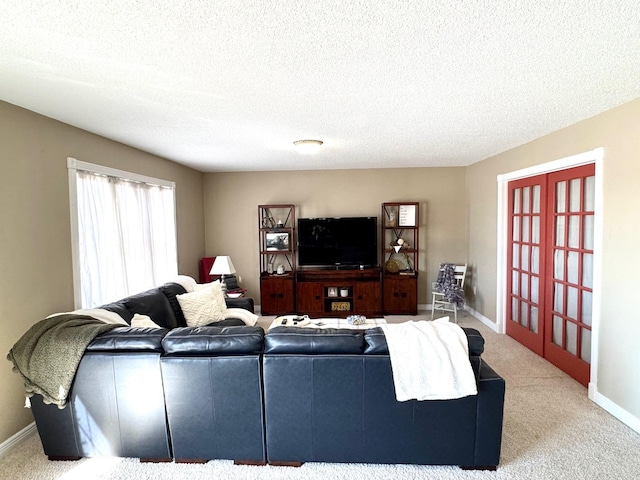 32661 County Road 16, Ross, MN 56751 - carpeted living area featuring baseboards, a textured ceiling, and french doors