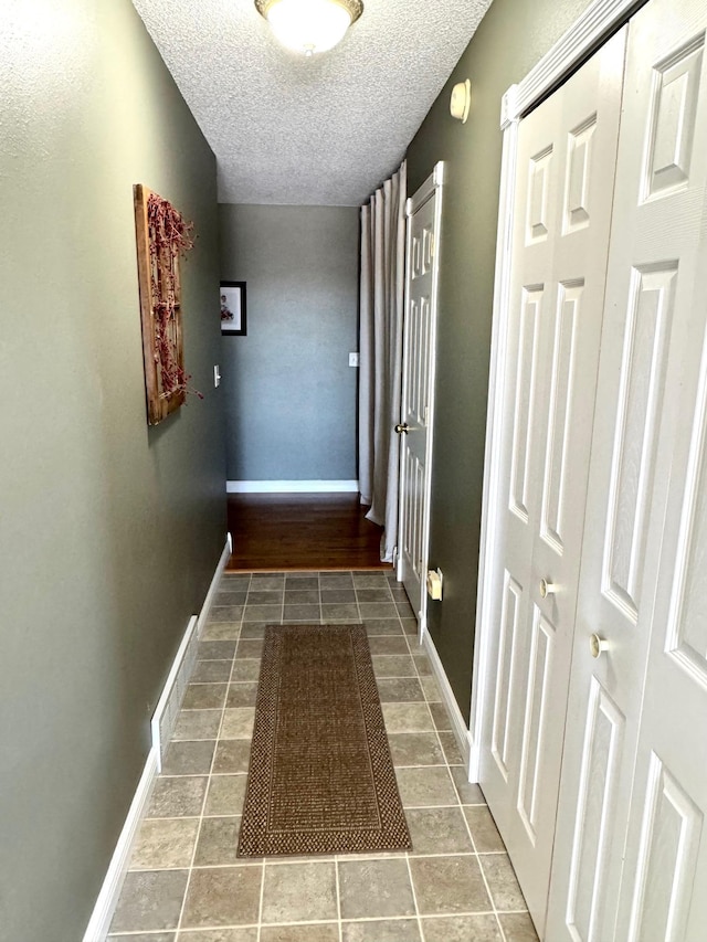 32661 County Road 16, Ross, MN 56751 - corridor with a textured ceiling, baseboards, and tile patterned flooring