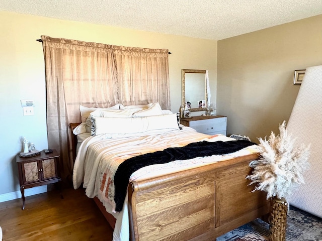32661 County Road 16, Ross, MN 56751 - bedroom with wood finished floors, a textured ceiling, and baseboards