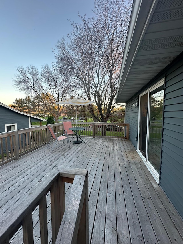 wooden terrace with outdoor dining area