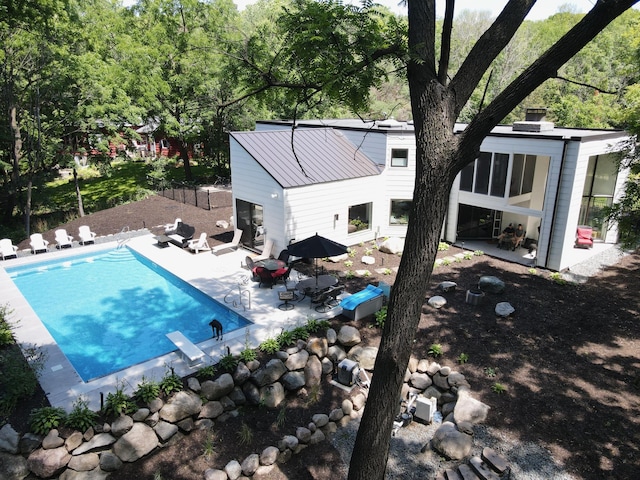 outdoor pool featuring a patio area and fence