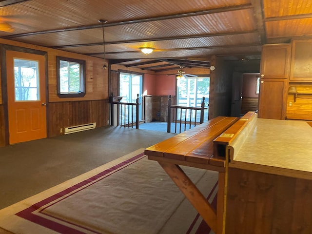 40884 Nature Ave, Fleming Twp, MN 56431 - kitchen featuring baseboard heating, wood walls, tile countertops, wooden ceiling, and a ceiling fan