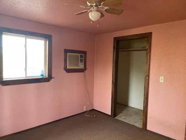 40884 Nature Ave, Fleming Twp, MN 56431 - unfurnished bedroom with a wall unit AC, a textured ceiling, a closet, carpet, and a ceiling fan