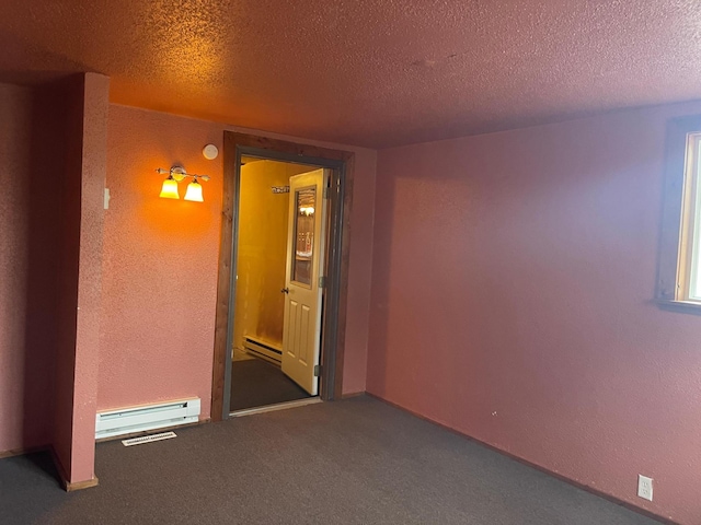 40884 Nature Ave, Fleming Twp, MN 56431 - empty room featuring baseboard heating, carpet floors, a textured ceiling, and a textured wall