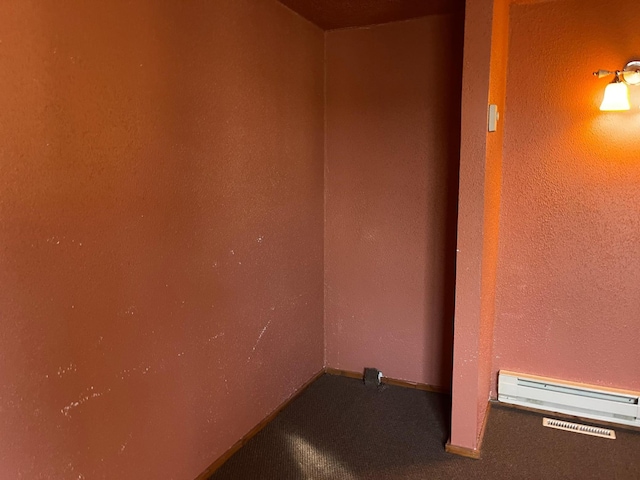 40884 Nature Ave, Fleming Twp, MN 56431 - unfurnished room featuring a baseboard radiator and carpet