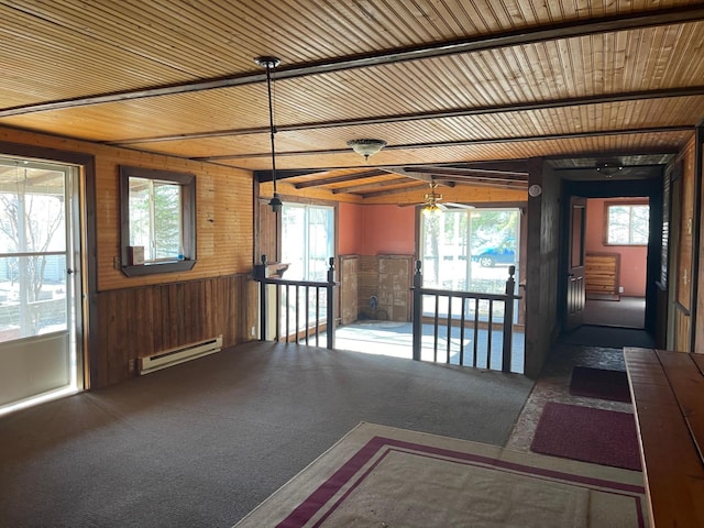 40884 Nature Ave, Fleming Twp, MN 56431 - foyer entrance with baseboard heating, wood walls, a ceiling fan, and carpet floors