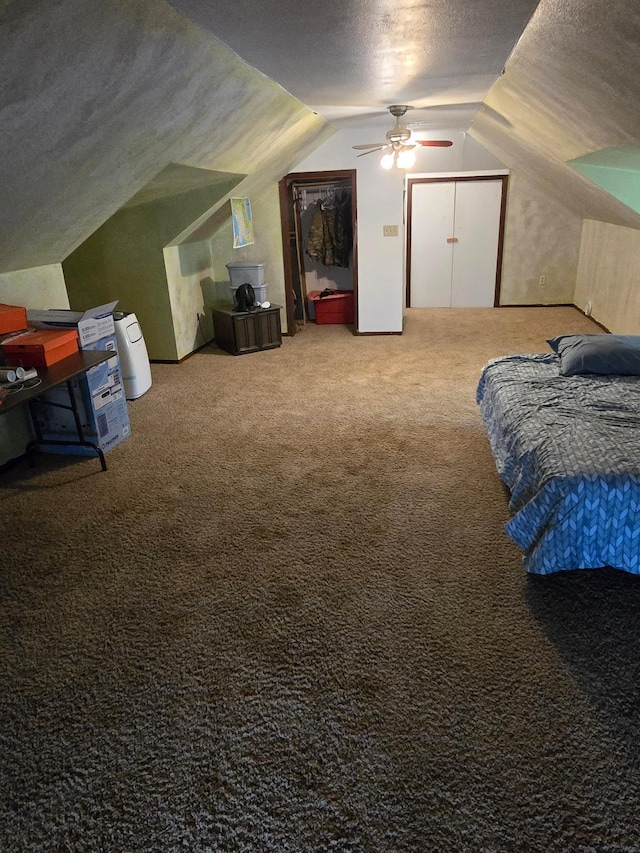 421 7th Ave SE, Pipestone, MN 56164 - carpeted bedroom featuring a textured ceiling, vaulted ceiling, and a ceiling fan