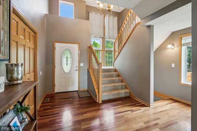 4022 Yosemite Ave S, Saint Louis Park, MN 55416 - foyer featuring light wood-style flooring, baseboards, a chandelier, and stairway