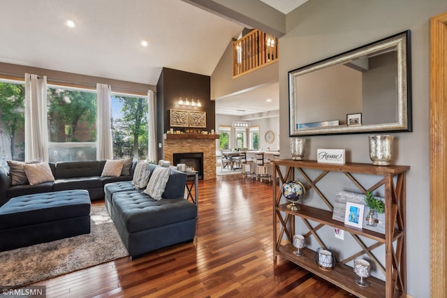 4022 Yosemite Ave S, Saint Louis Park, MN 55416 - living room featuring wood-type flooring, a stone fireplace, high vaulted ceiling, and recessed lighting
