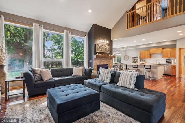 4022 Yosemite Ave S, Saint Louis Park, MN 55416 - living room featuring high vaulted ceiling, a stone fireplace, wood finished floors, and recessed lighting