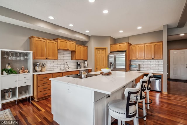 4022 Yosemite Ave S, Saint Louis Park, MN 55416 - kitchen featuring dark wood finished floors, stainless steel fridge with ice dispenser, a sink, a kitchen island, and black electric stovetop