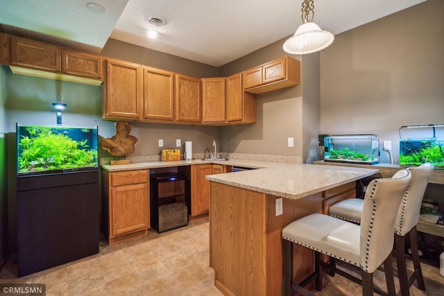 4022 Yosemite Ave S, Saint Louis Park, MN 55416 - kitchen with a sink, a breakfast bar, visible vents, a peninsula, and wine cooler