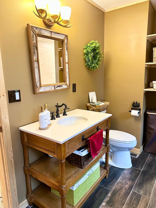 38985 337th Ln, Aitkin, MN 56431 - bathroom featuring wood finished floors, toilet, vanity, and baseboards