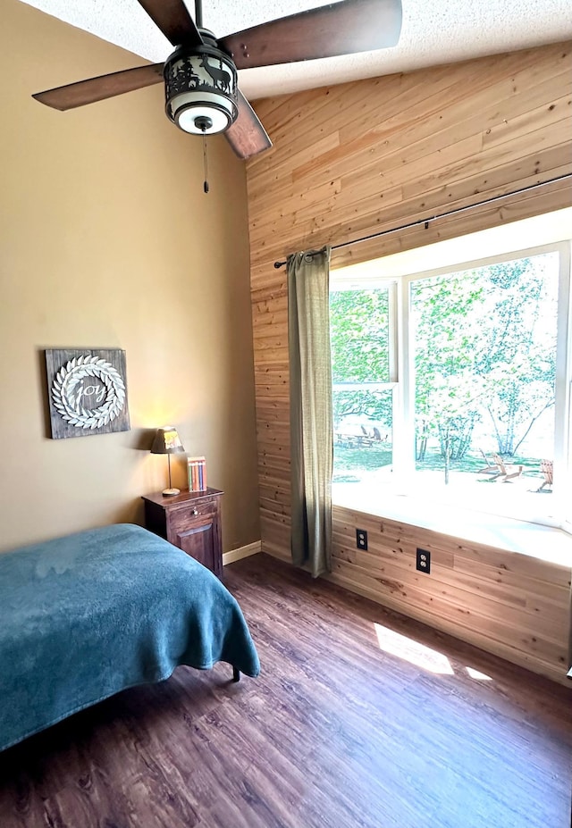 38985 337th Ln, Aitkin, MN 56431 - bedroom with wood finished floors, wooden walls, a ceiling fan, and baseboards