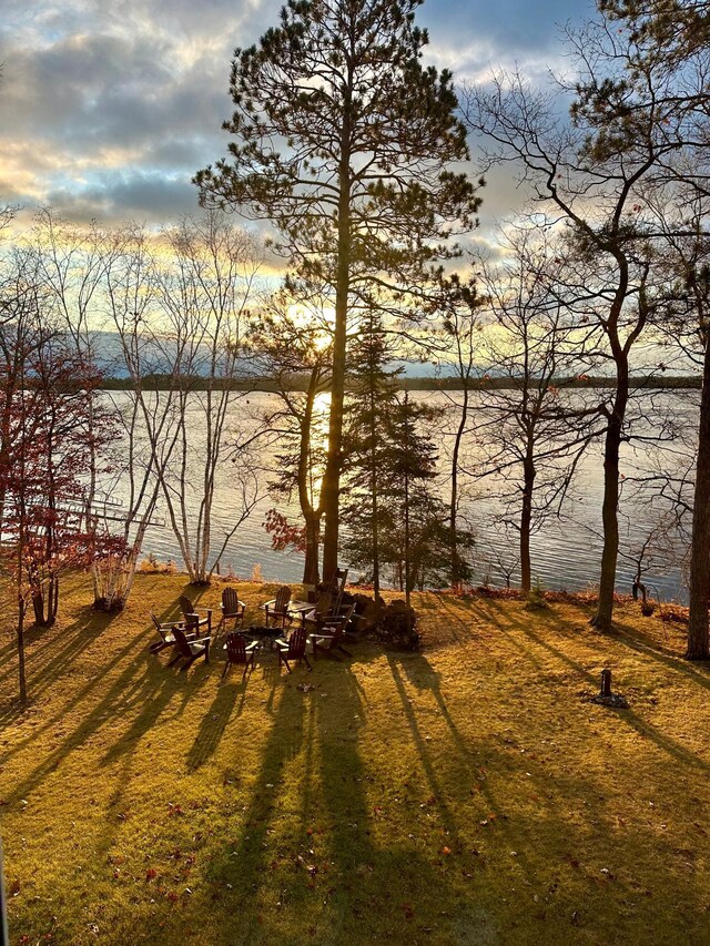 38985 337th Ln, Aitkin, MN 56431 - view of green lawn with an outdoor fire pit and a water view