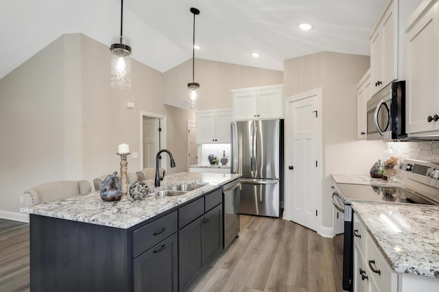 10052 177th Cir NW, Elk River, MN 55330 - kitchen with white cabinets, a sink, light wood-type flooring, vaulted ceiling, and stainless steel appliances