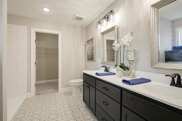 10052 177th Cir NW, Elk River, MN 55330 - bathroom with double vanity, toilet, tiled shower, visible vents, and a sink
