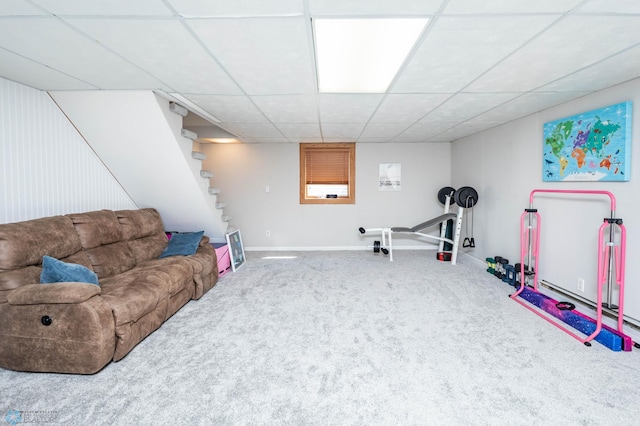 interior space with baseboards, stairs, and a drop ceiling