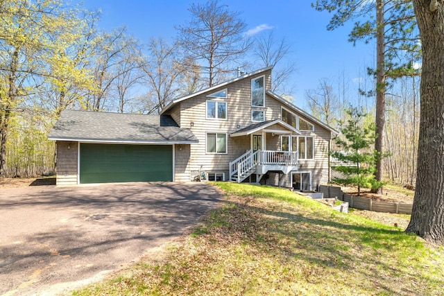 3626 Bay Dr, Danbury, WI 54830 - view of front of house featuring asphalt driveway, a garage, and roof with shingles