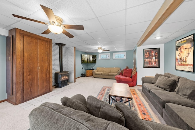 3626 Bay Dr, Danbury, WI 54830 - living area featuring light colored carpet, a wood stove, a ceiling fan, a drop ceiling, and baseboards