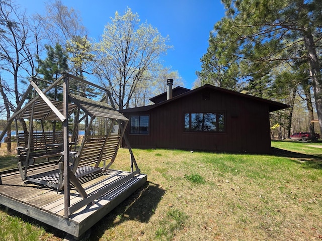 view of property exterior with a wooden deck, a yard, and a gazebo
