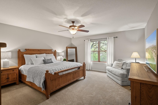bedroom featuring light carpet and a ceiling fan