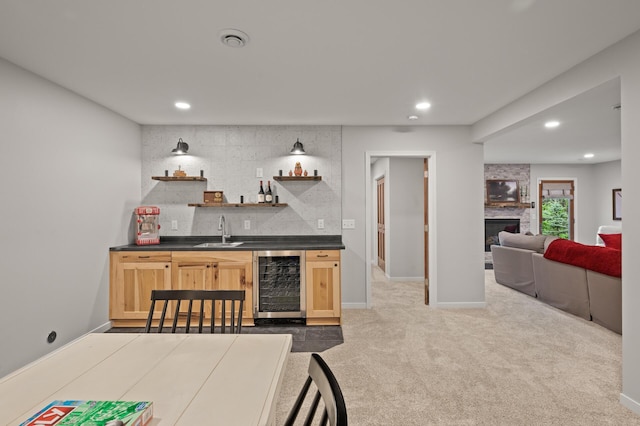 bar with wet bar, recessed lighting, decorative backsplash, beverage cooler, and a sink