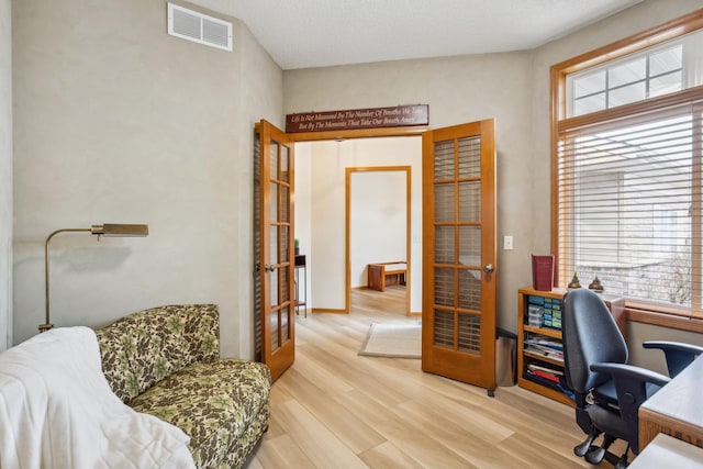 office featuring french doors and light wood-style flooring