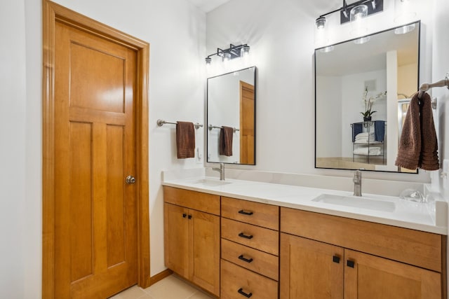bathroom with double vanity and tile patterned flooring