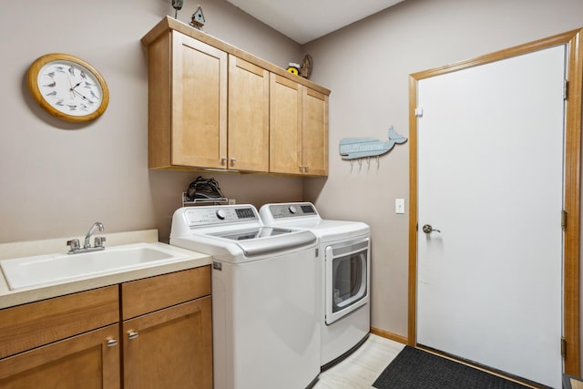 laundry area featuring washing machine and clothes dryer and cabinet space