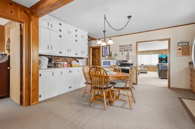 42271 Vista Road, East Side Twp, MN 56342 - dining area with light carpet, ornamental molding, and a chandelier