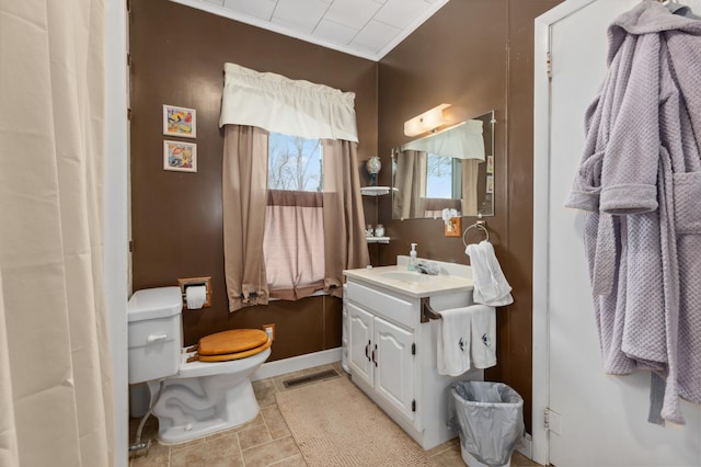 42271 Vista Road, East Side Twp, MN 56342 - bathroom with toilet, vanity, crown molding, and baseboards