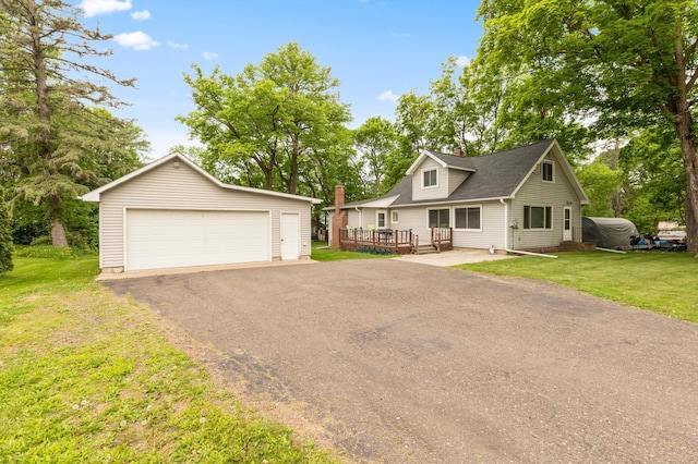 42271 Vista Road, East Side Twp, MN 56342 - view of front of property featuring a detached garage, an outbuilding, a wooden deck, and a front lawn