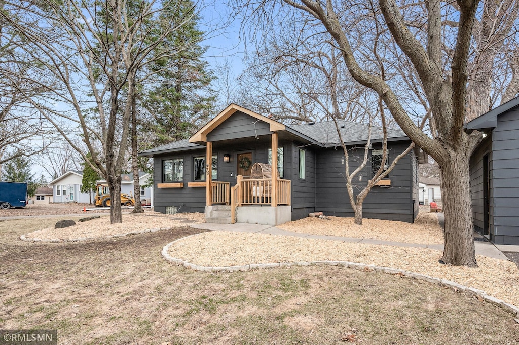75 Ash St, Mahtomedi, MN 55115 - view of front facade featuring roof with shingles and covered porch