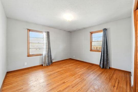 7335 Penn Ave S, Richfield, MN 55423 - empty room with light wood-style flooring and baseboards
