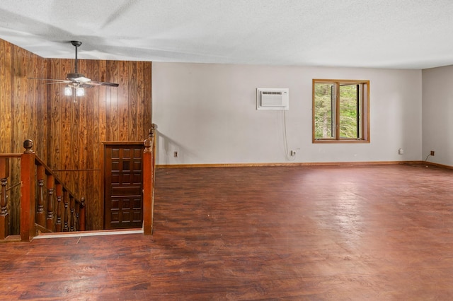 409 Dale Dr SE, Remer, MN 56672 - spare room featuring an AC wall unit, wood finished floors, a ceiling fan, and a textured ceiling