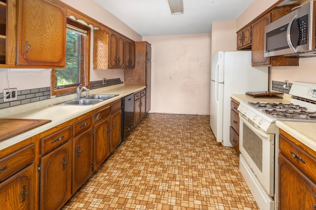 409 Dale Dr SE, Remer, MN 56672 - kitchen with white gas range oven, stainless steel microwave, dishwasher, light countertops, and brown cabinets